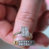 Two diamond rings on a person's finger with a blurred background